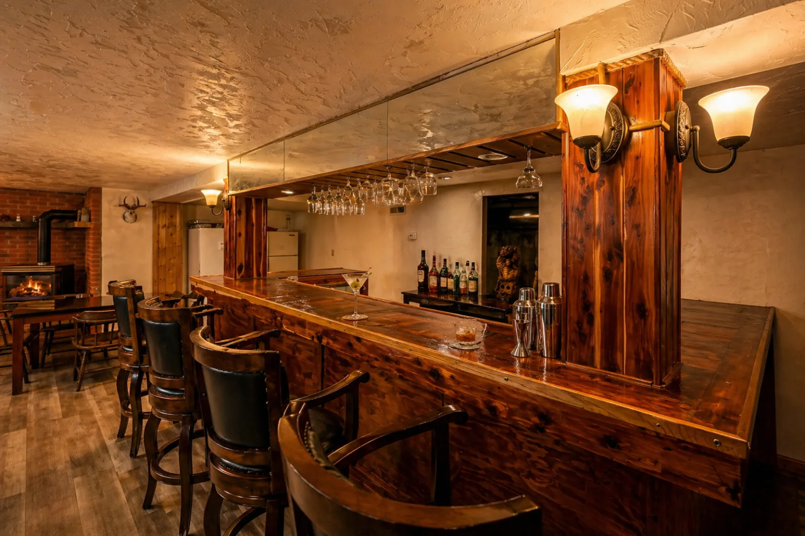 Bar seating beside the wood stove and river-rock hearth at Harbour Hideout.